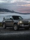 A land rover is parked on the side of the road