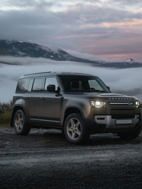 A land rover is parked on the side of the road