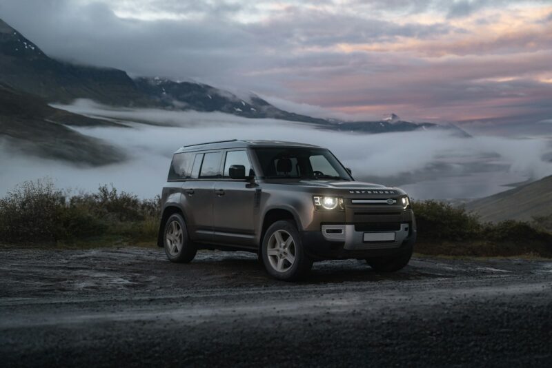 A land rover is parked on the side of the road