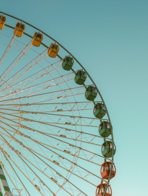 A large ferris wheel sitting next to a tall building