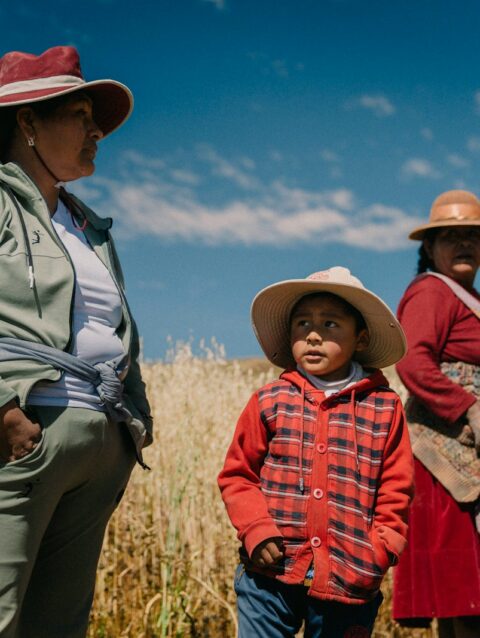 A group of people standing next to each other in a field