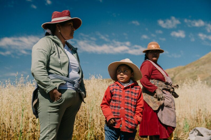 A group of people standing next to each other in a field