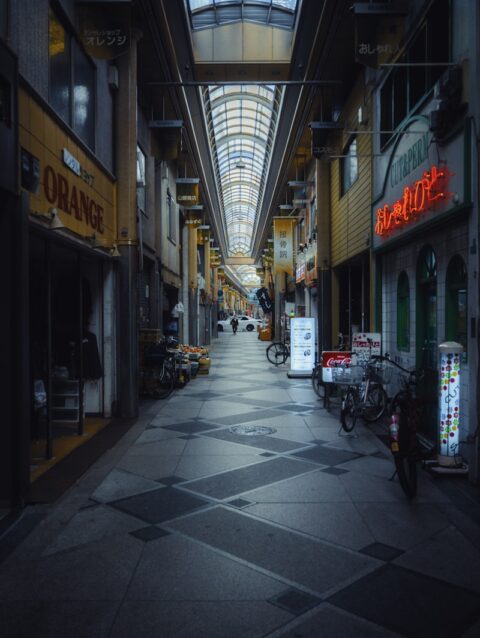 A narrow city street with a skylight above it