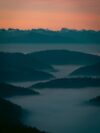 A view of a mountain range covered in fog