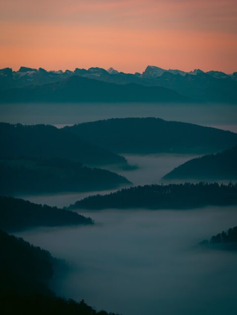 A view of a mountain range covered in fog