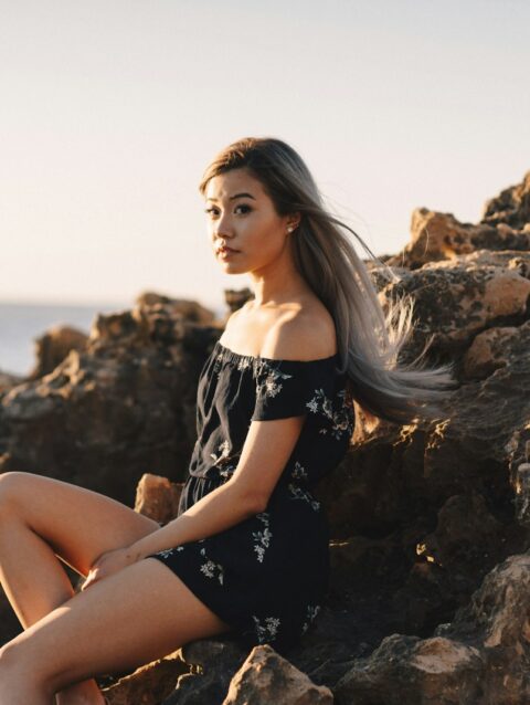 woman sitting on rock