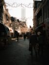 A couple of people that are walking down a street