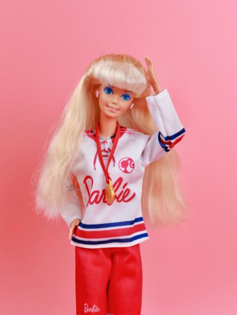 A barbie doll with blonde hair and blue eyes