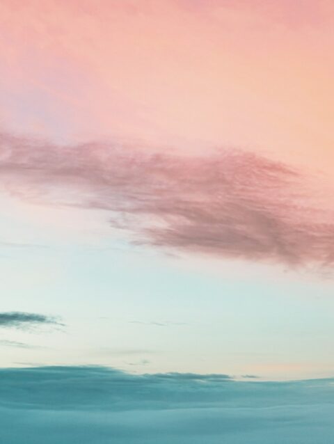A pink and blue sky with some clouds